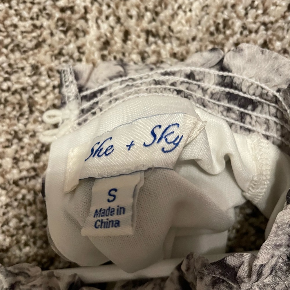 Wedding Guest Dress: High neck fit and flare tier dress. Snake skin print sheath